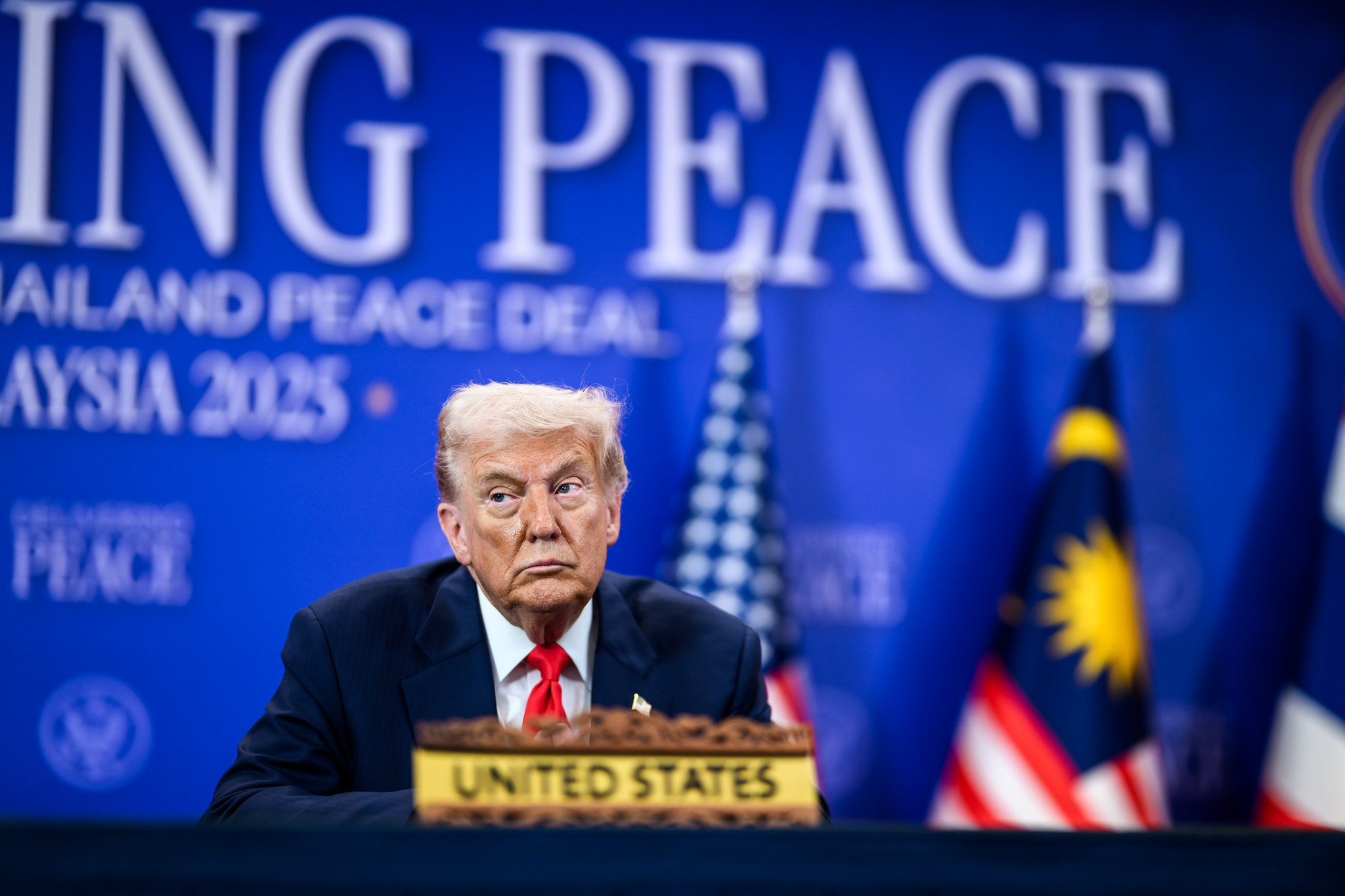 President Donald Trump looks on as Malaysian Prime Minister Seri Anwar Ibrahim delivers remarks before signing the Kuala Lumpur Accord, Saturday, Oct. 25, 2025, at the ASEAN Summit in Kuala Lumpur, Malaysia.