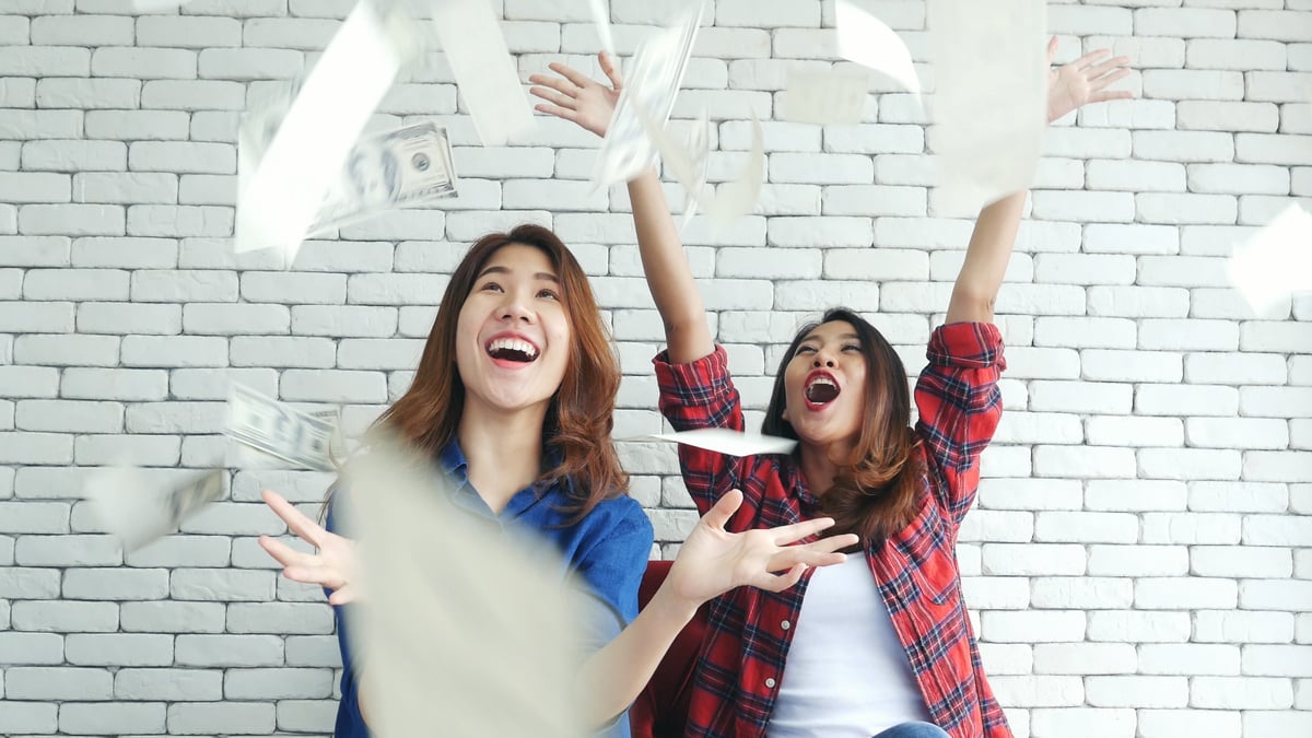 People excited throwing money up