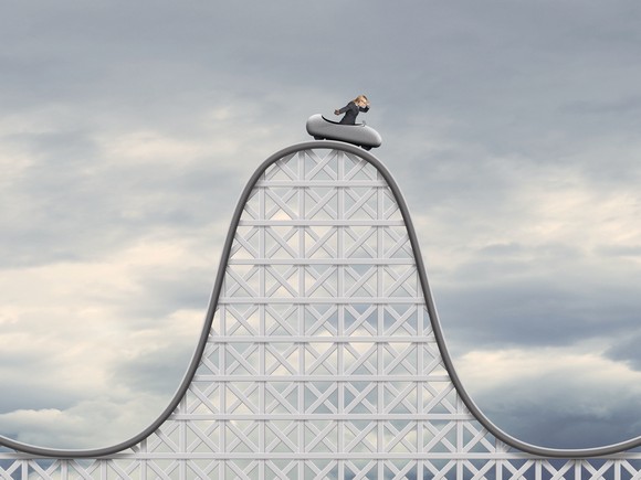 Person in car at top of roller coaster.