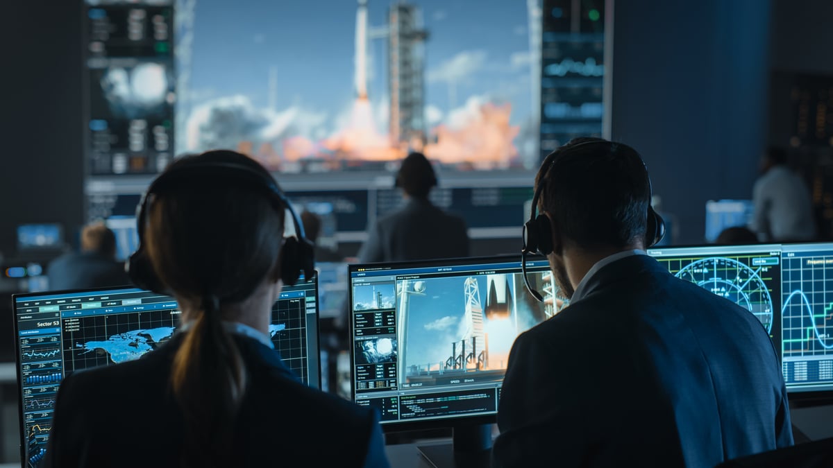 engineers monitor a rocket launch.