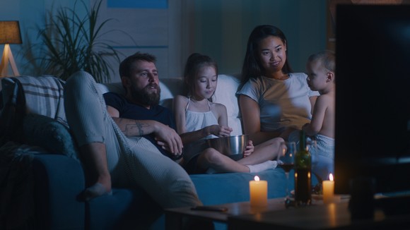 Family watching TV together.