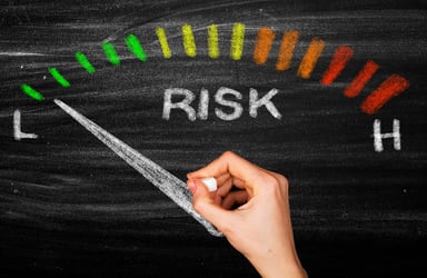 Chalkboard drawing of a risk dial shows low risk.