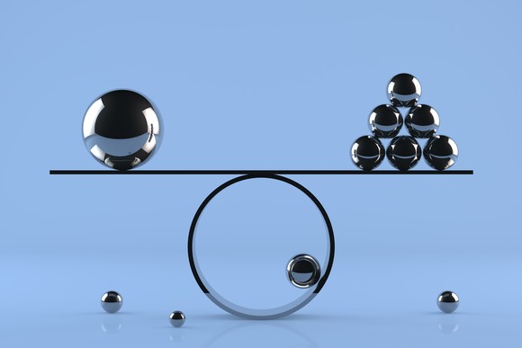 Metallic balls of various sizes are balanced on a large ring.