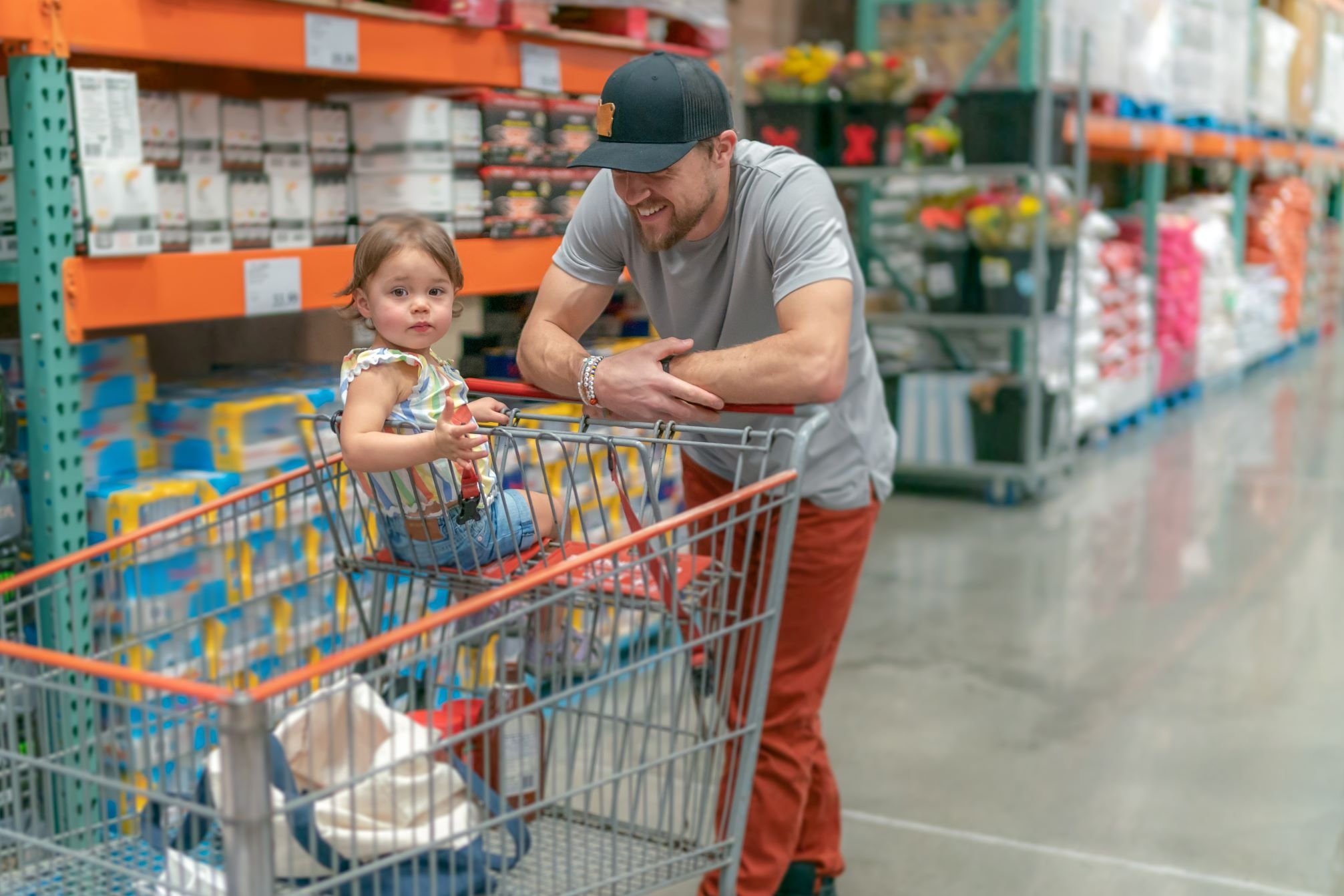 Person shopping with their child in a warehouse.