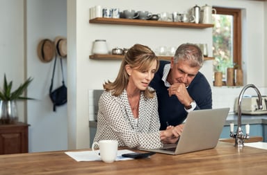 A couple looking at a computer screen.