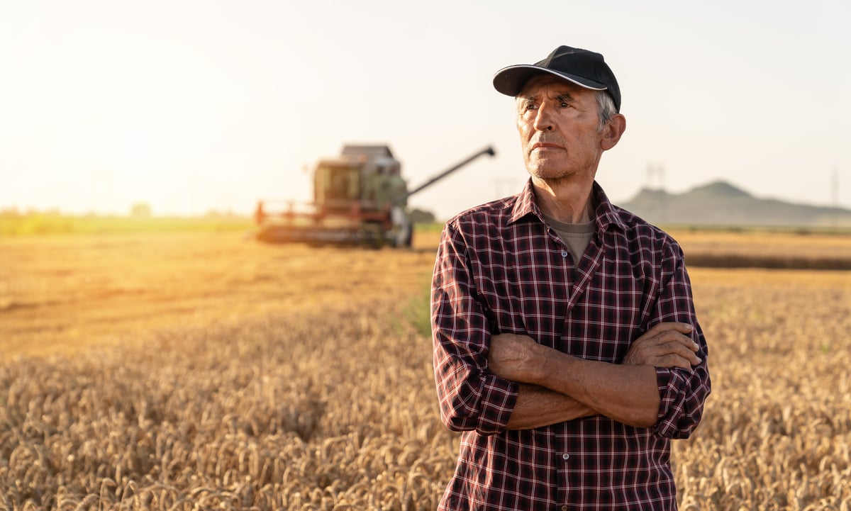 A worker stands in a field.