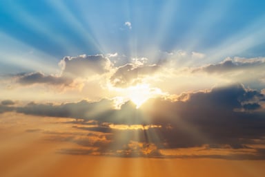 Beautiful day with sun shining through clouds.