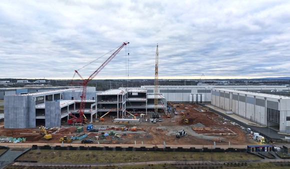 Data center construction with machines and equipment in background.