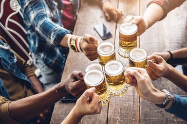 group-of-beer-drinkers-toasting-with-mugs