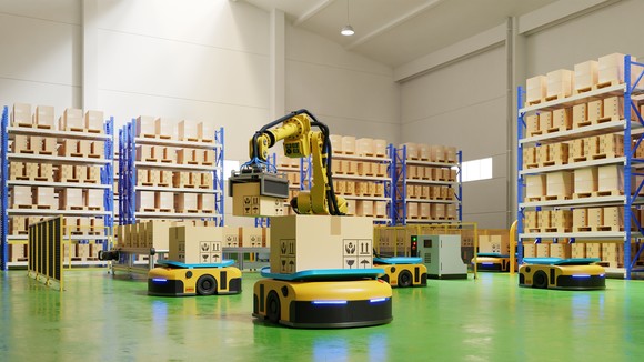Robotic arms carrying boxes in a warehouse.