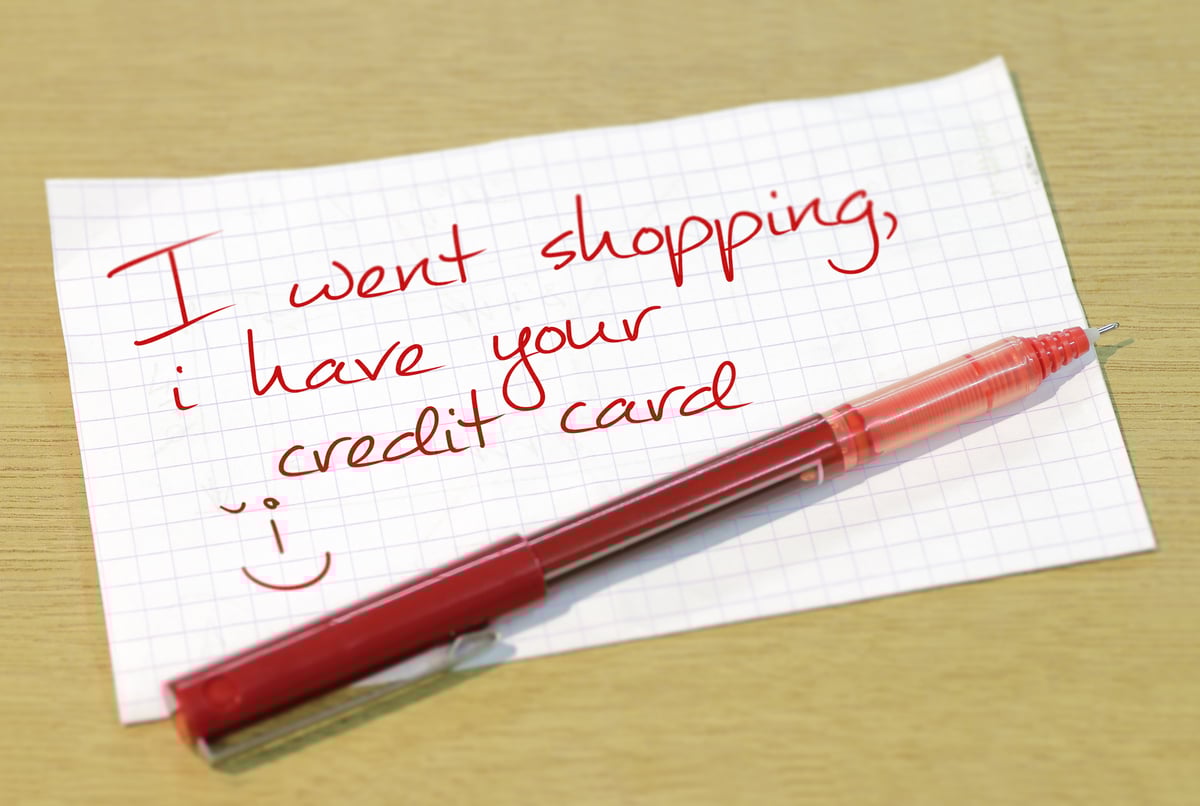 A note written in red ink that says I went shopping, I have your credit card.