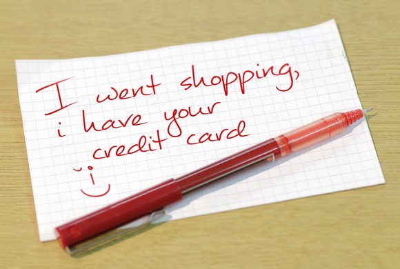 A note written in red ink that says I went shopping, I have your credit card.
