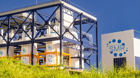 A small modular reactor facility under a clear blue sky. 