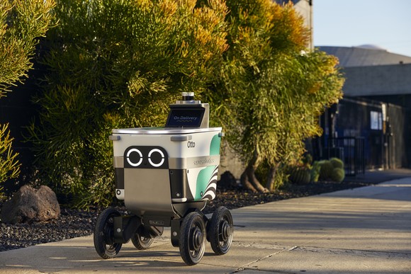 serve robotics delivery robot moving down a road.