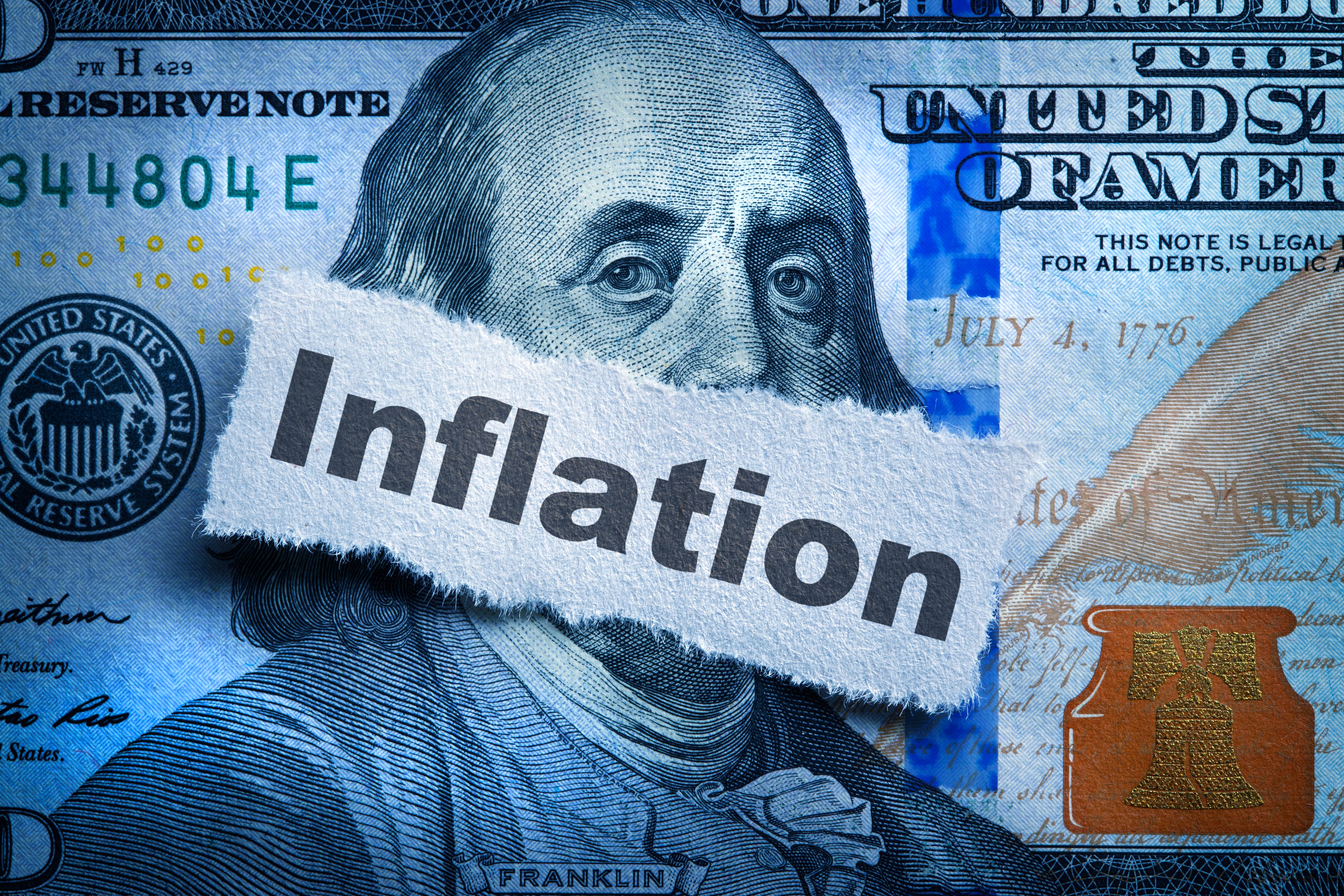 Ben Franklin on one hundred dollar bill with mouth covered by the word inflation. 