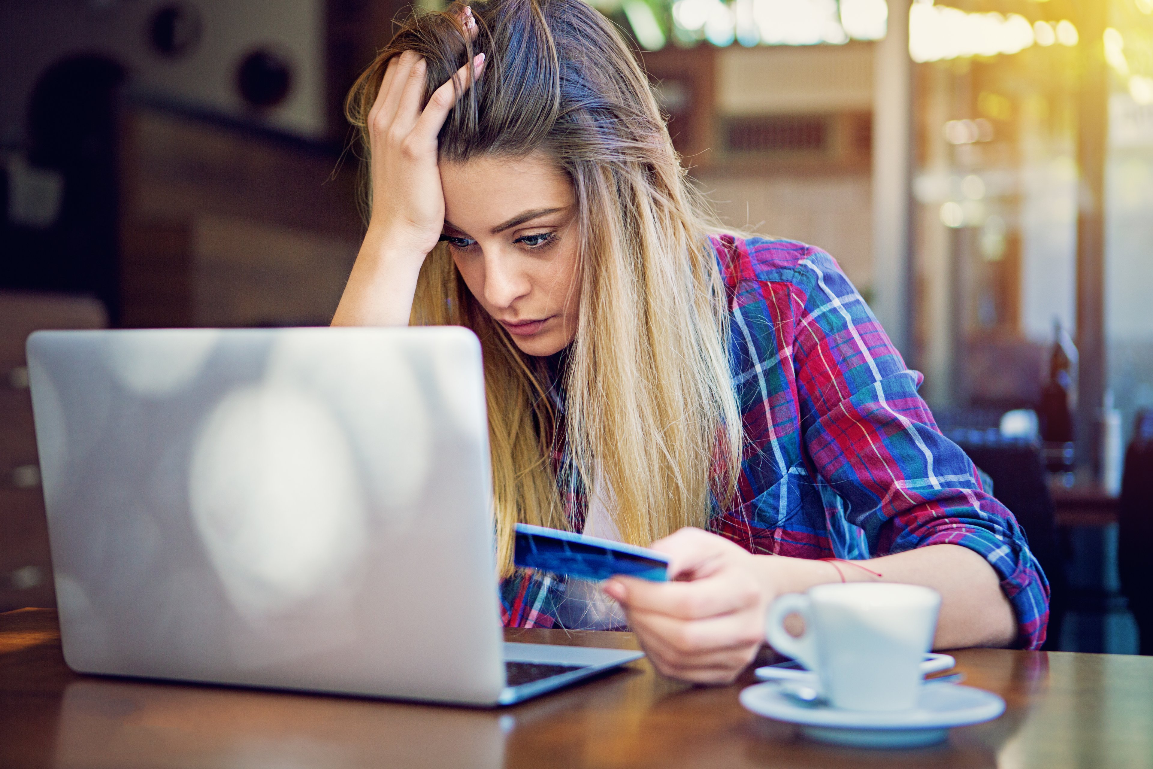 facepalming investor sits at desk with computer