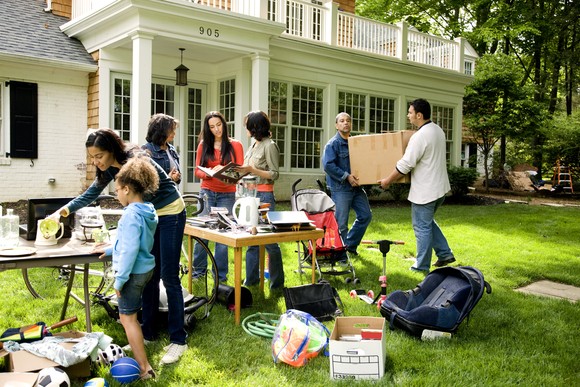 People gathering at a neighborhood yard sale.