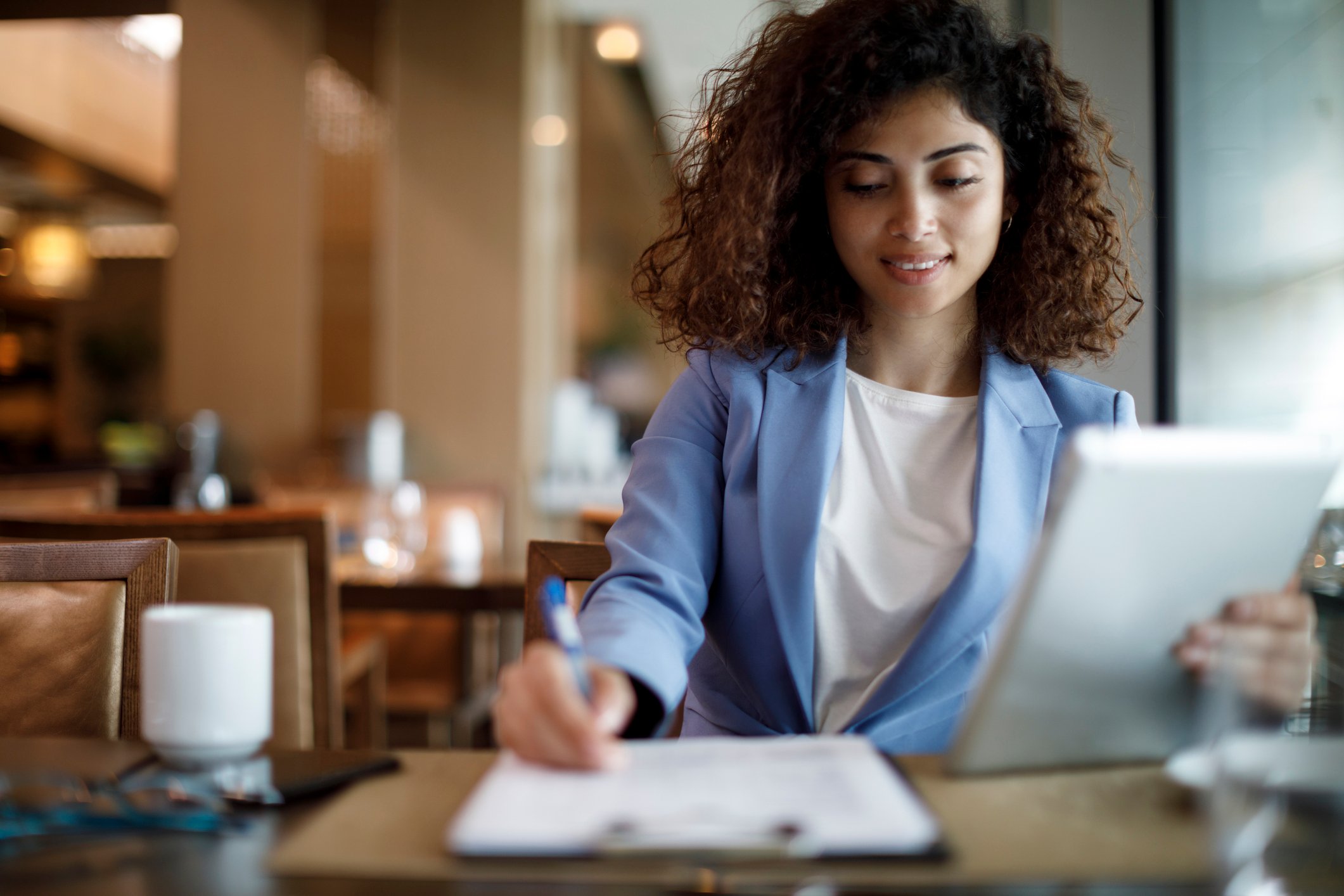 GettyImages-woman works at a cafe using tablet