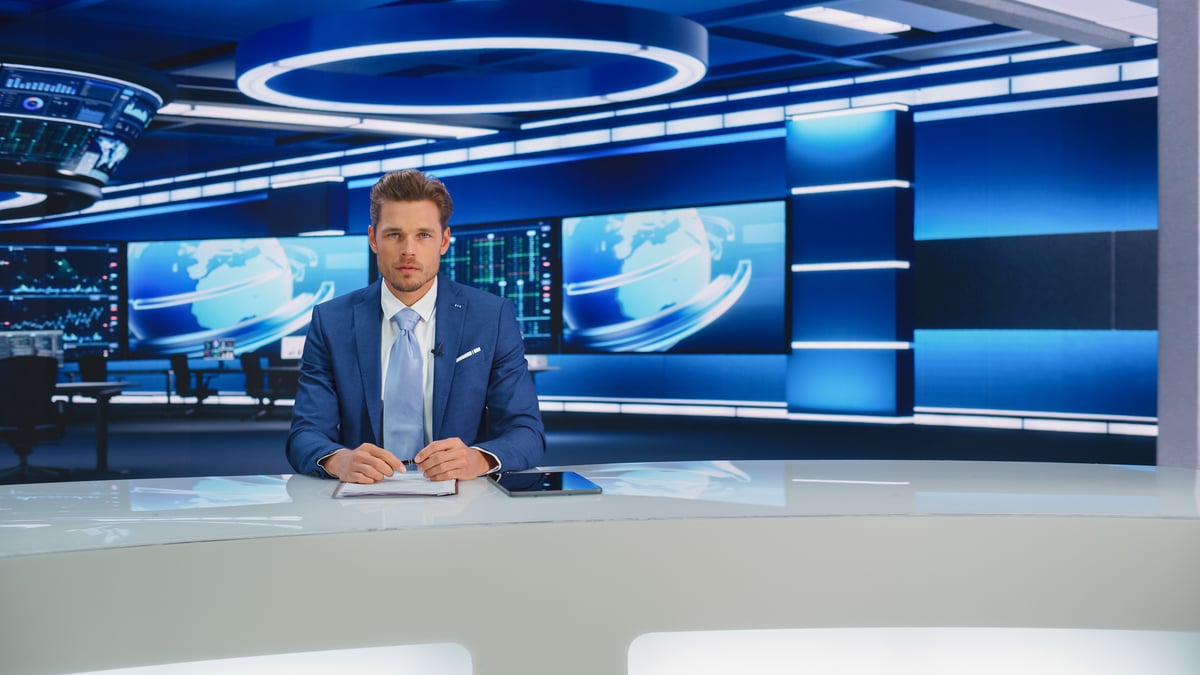 News anchor with blue backdrop1407334229