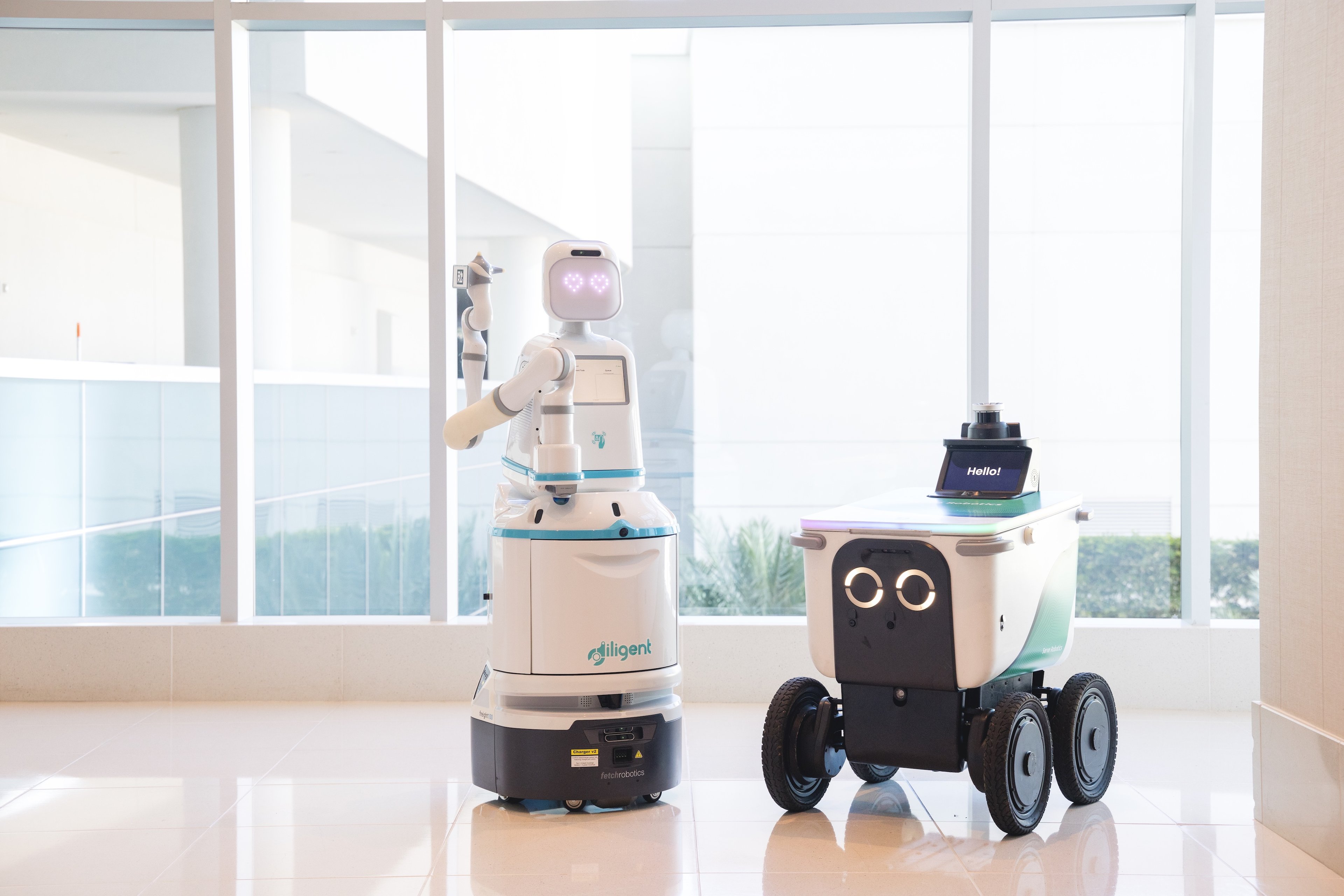 Serve and Diligent Robotics robots side by side. 