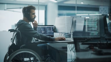Person in a wheelchair working at a computer