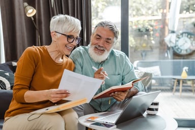 Excited couple looking at document together