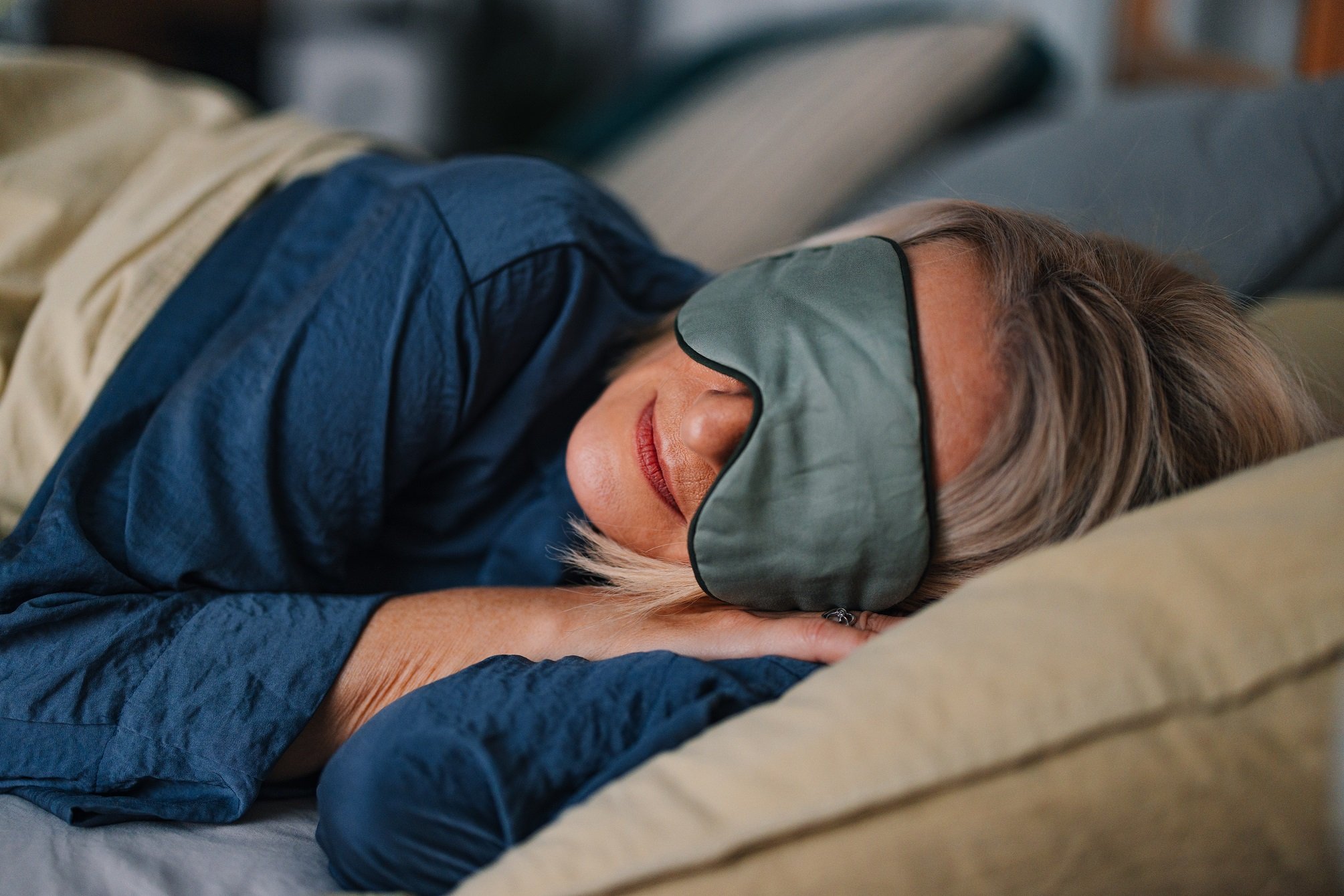 Person in bed with a sleep mask.