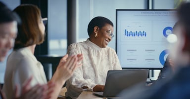 People at a meeting with data on screens