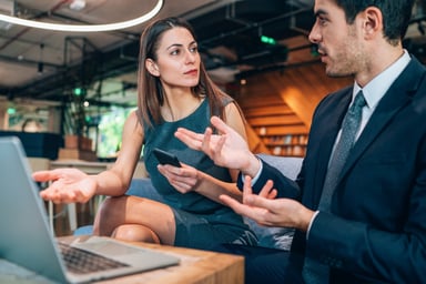 Two analysts arguing over a laptop