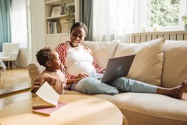 Mother and child relaxing on a sofa.