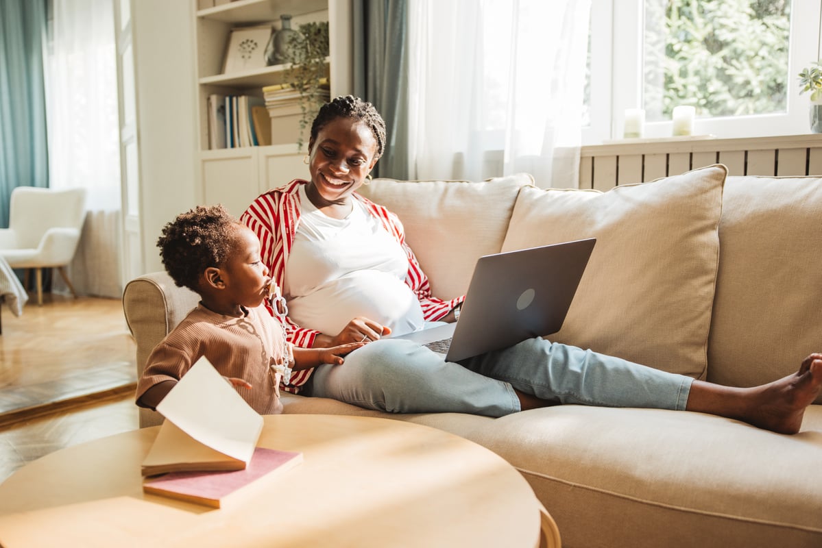 Mother and child relaxing on a sofa.