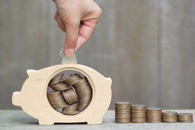 putting coins in a piggy bank