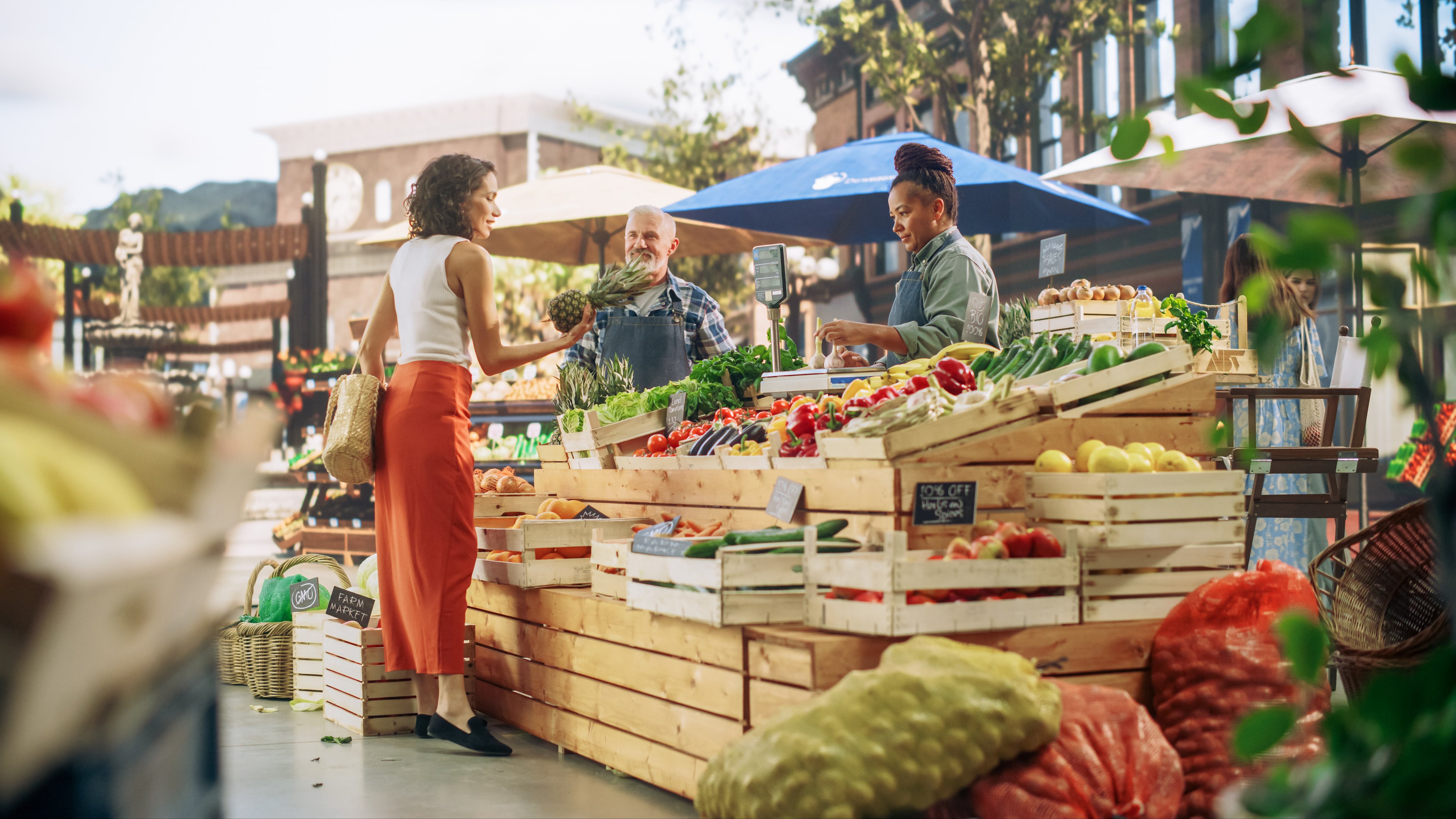 A woman buys fruit from a fruit vendor. 