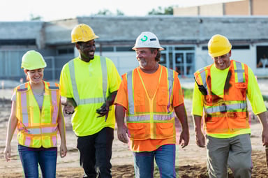 four construction workers walking