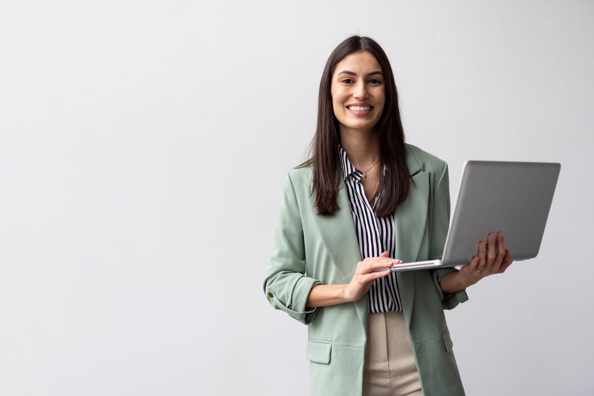 Professional_smiling_while_holding_a_laptop