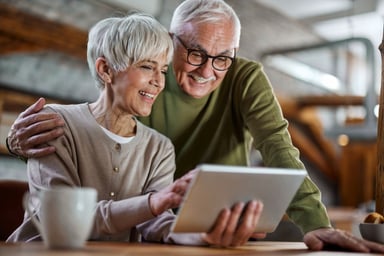 A couple looking at a tablet.