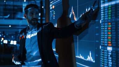 Person presenting a chart at a company meeting.