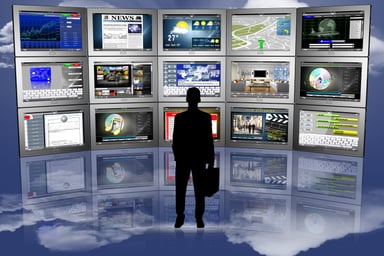 Person in front of various news screens