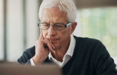 Worried investor looking at a computer.