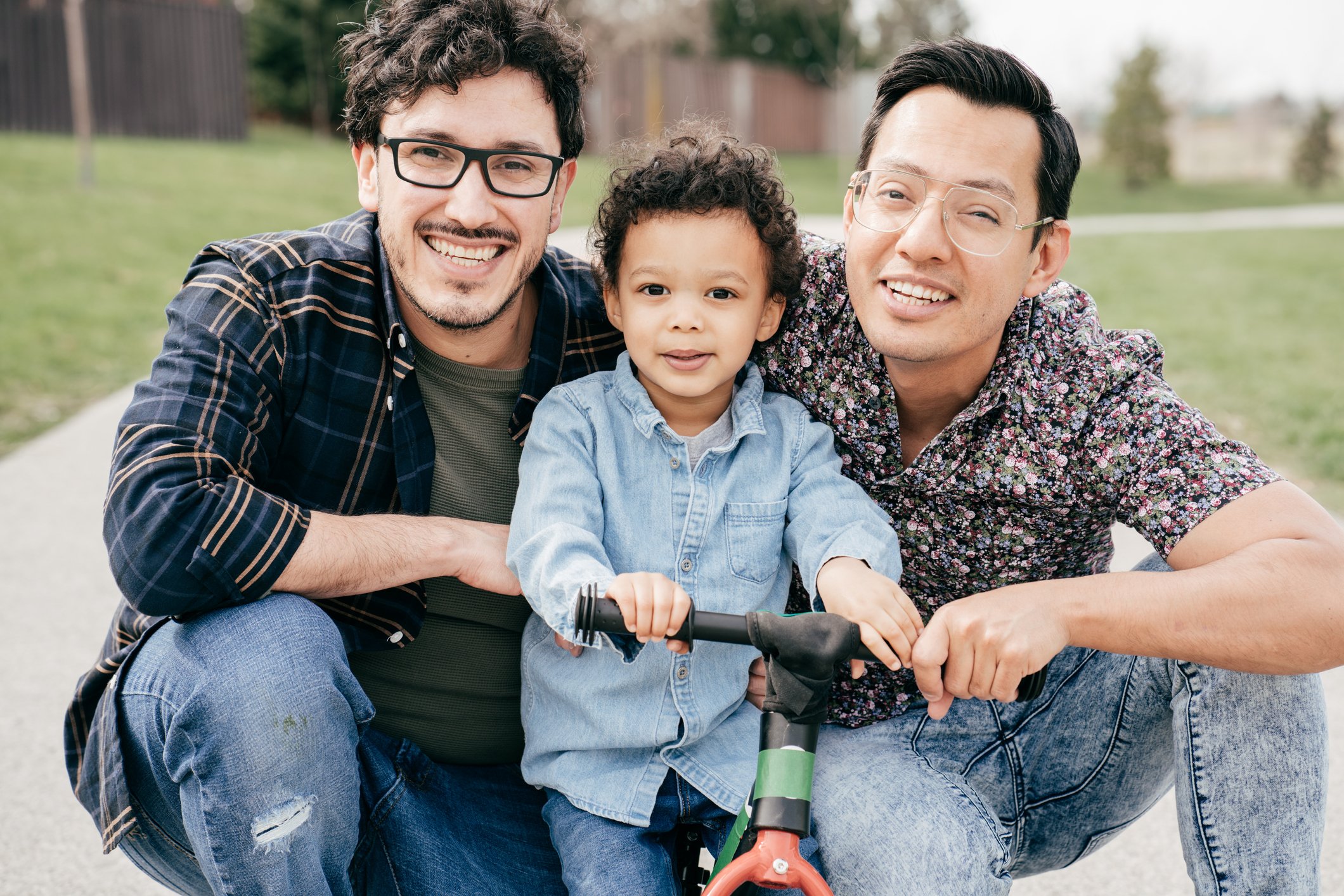 Getty - happy couple posing outside with child