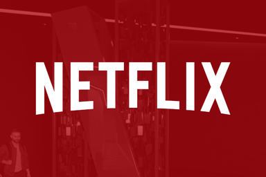 Netflix logo on red filter_The Motley Fool