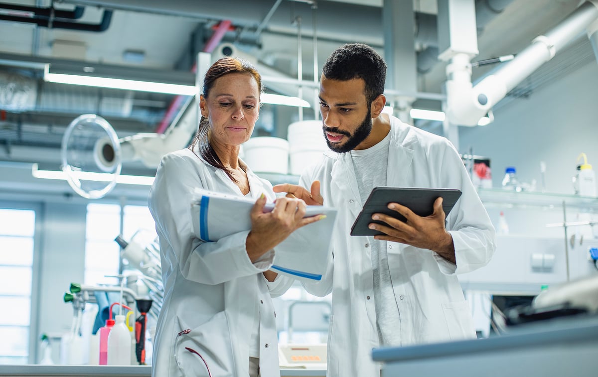 Two cancer scientists working together in a lab.