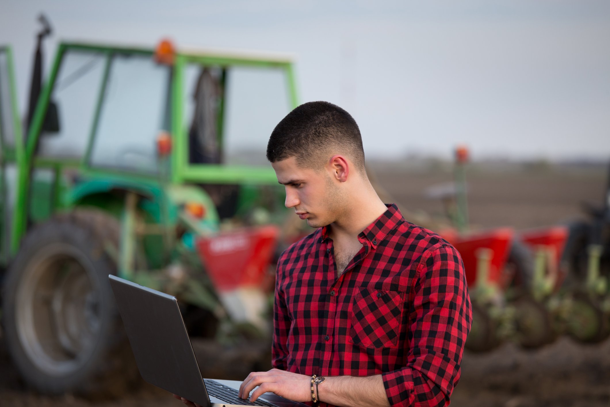 Image 8 A farmer checks his crops on a laptop