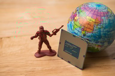 a semiconductor near a toy solider and a globe