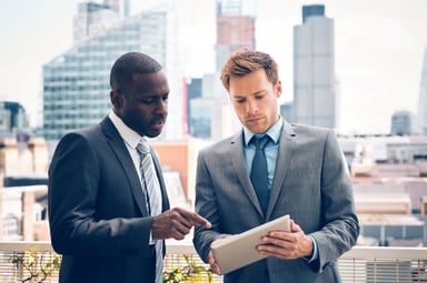 Business people looking at a tablet.