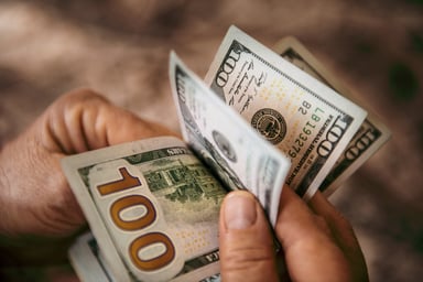 person holding hundred dollar bills 2