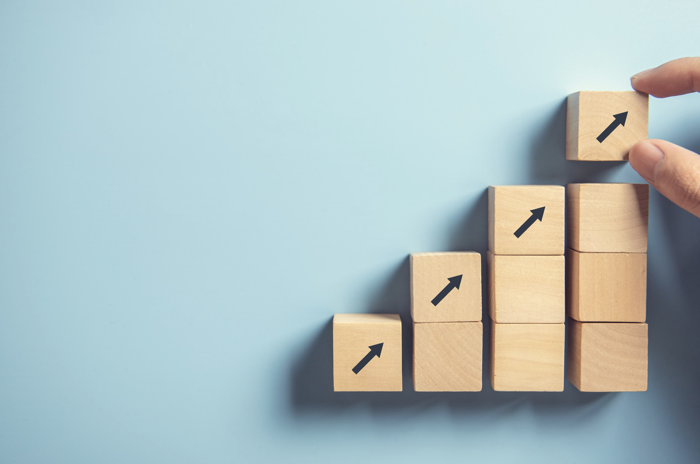 blocks with arrows pointing up building growth