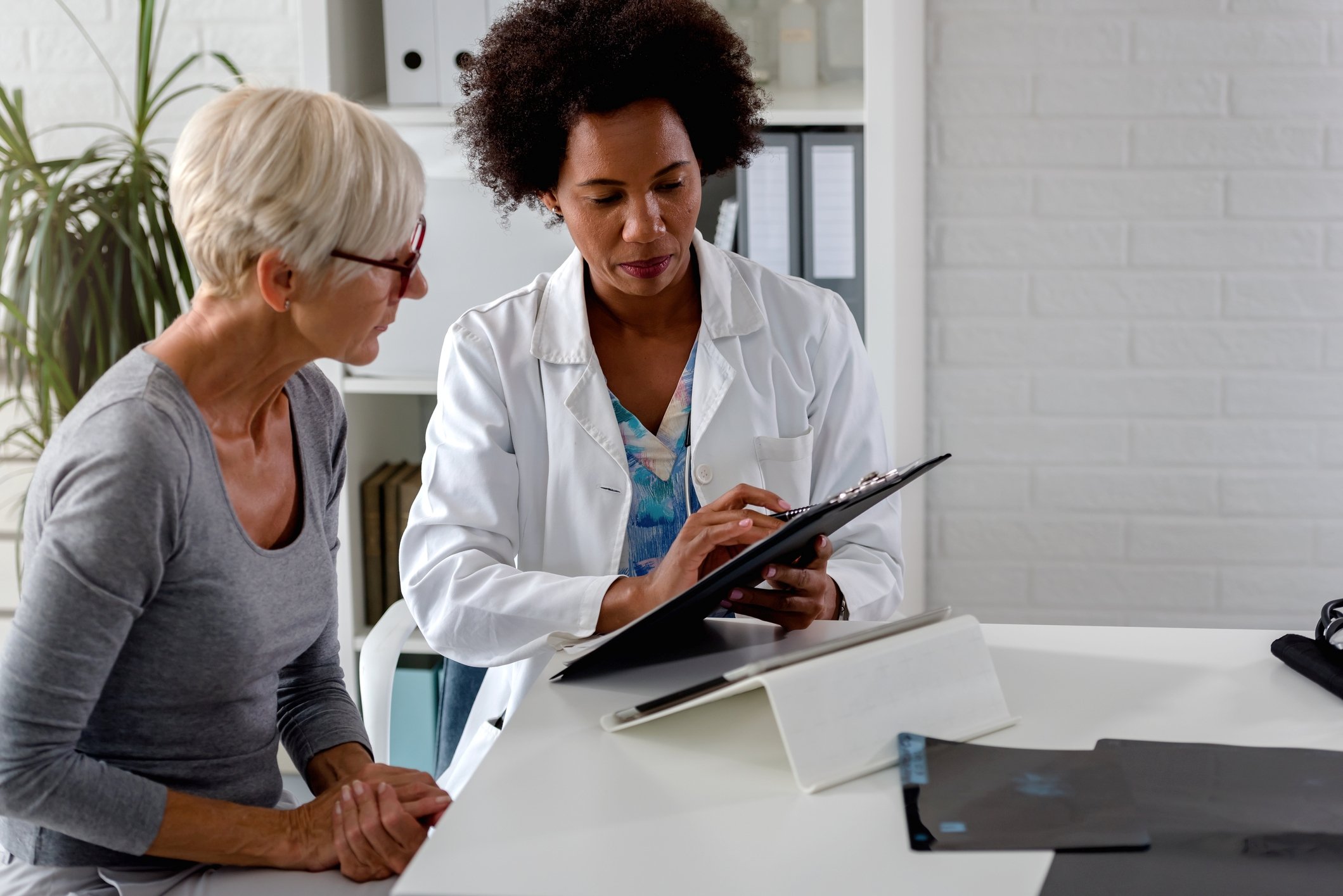 Doctor showing patient a chart.