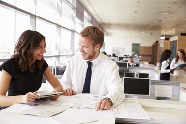Professionals_talking_and_laughing_in_an_office