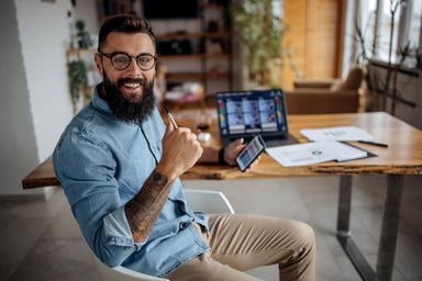 happy stock investor holding smartphone.